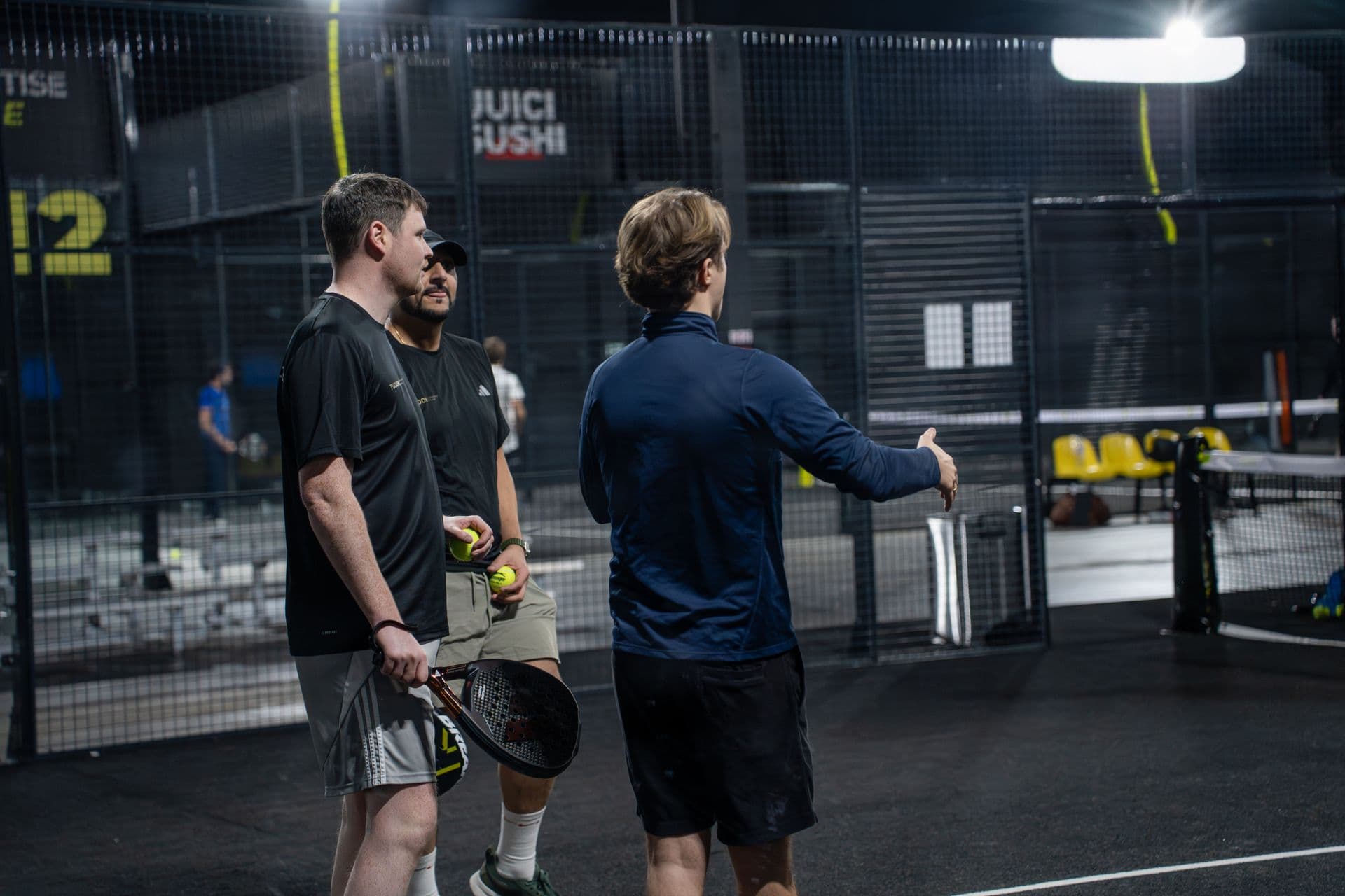 Network Padel players mid-rally